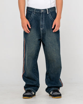 Man wearing Flip Daddy 2.0 Jean in Dark N Dirty / Orange