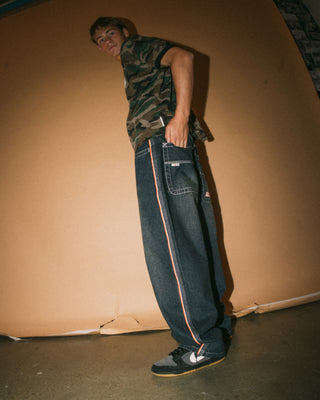 Man wearing Flip Daddy 2.0 Jean in Dark N Dirty / Orange