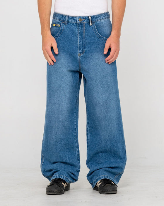 man-wearing-big-foot-baggy-jean-in-blasted-middy-blue