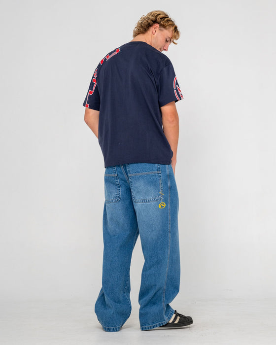 man-wearing-big-foot-baggy-jean-in-blasted-middy-blue
