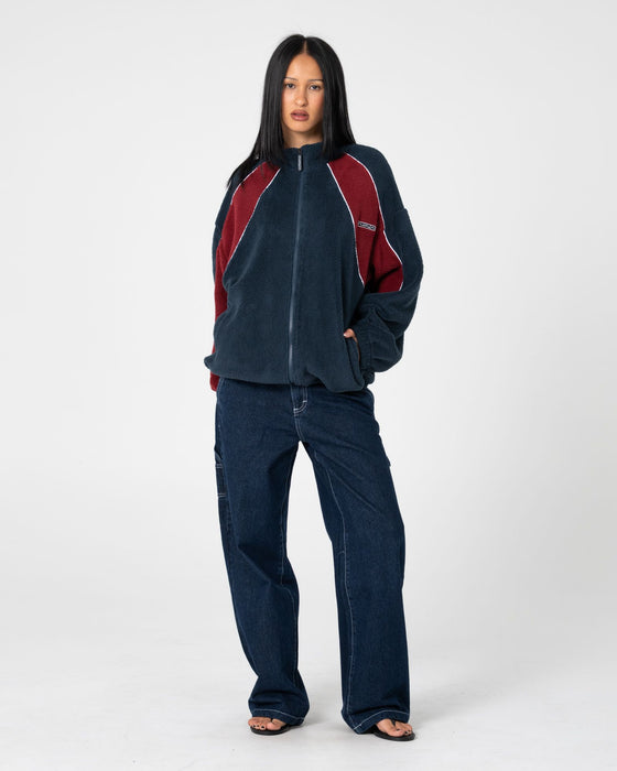 woman-wearing-two-tides-zip-through-sherpa-fleece-in-navy-red