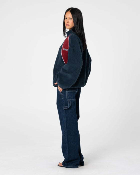 woman-wearing-two-tides-zip-through-sherpa-fleece-in-navy-red