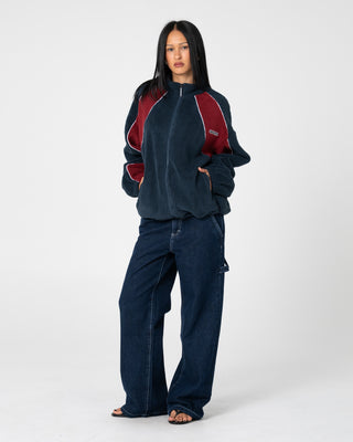 Woman wearing Two Tides Zip Through Sherpa Fleece in Navy / Red