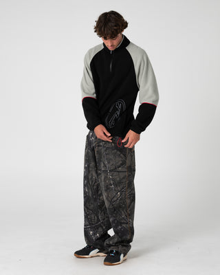 Man wearing Tectonic Quarter Zip Polar Fleece in Black