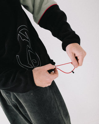 Man wearing Tectonic Quarter Zip Polar Fleece in Black