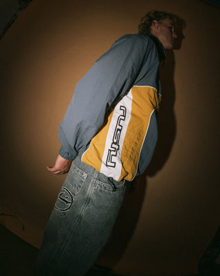 Man wearing Hocus Pocus Zip Thru Jacket in Steel Blue