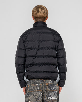 Man wearing Pit Viper Puffer Jacket in Black