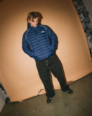 Man wearing Pipe Line Puffer Jacket in Navy Blue