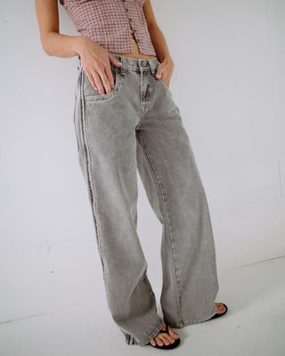 Woman wearing Flip Mommy Low Rise Wide Leg Denim Jean in London Summer / Baby Pink