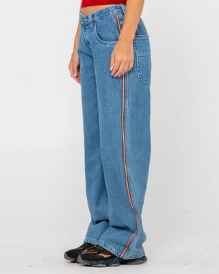 Woman wearing Flip Mommy Low Rise Wide Leg Denim Jean in Middy Blue / Orange