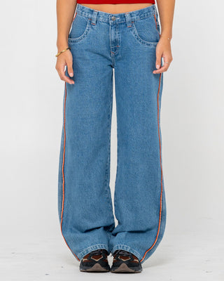 Woman wearing Flip Mommy Low Rise Wide Leg Denim Jean in Middy Blue / Orange