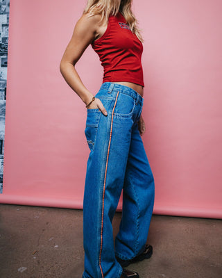 Woman wearing Flip Mommy Low Rise Wide Leg Denim Jean in Middy Blue / Orange