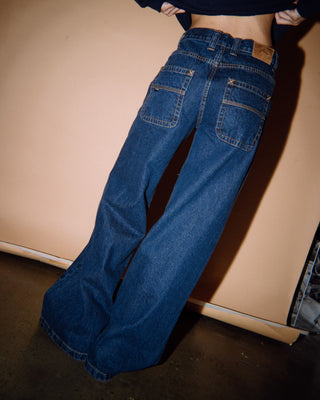 Woman wearing Wendy Wide Low Rise Denim Jean in Deep Sea Blue