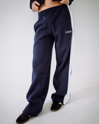 Woman wearing Retro Lines Wide Leg Track Pant in Navy Blue