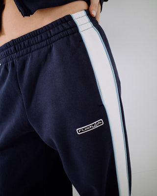 Woman wearing Retro Lines Wide Leg Track Pant in Navy Blue