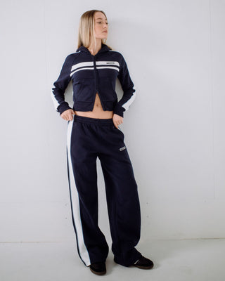 Woman wearing Retro Lines Wide Leg Track Pant in Navy Blue