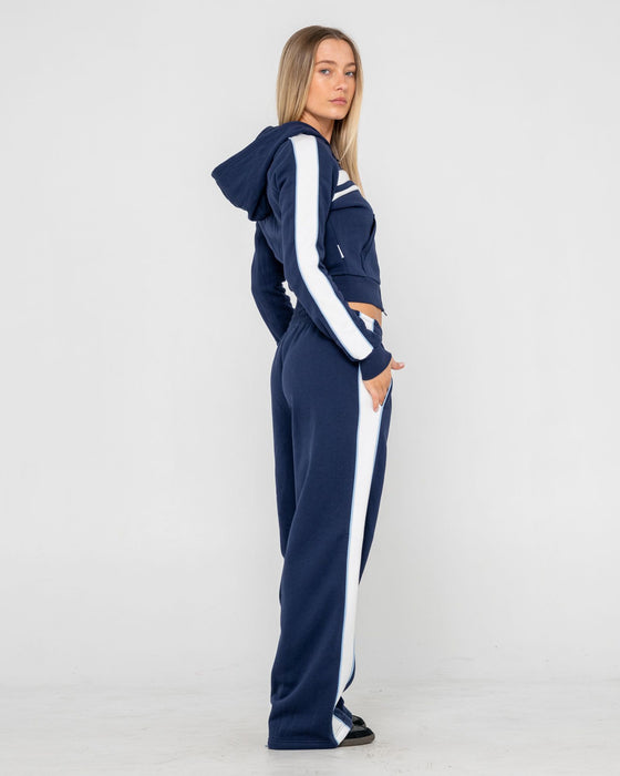 woman-wearing-retro-lines-wide-leg-track-pant-in-navy-blue