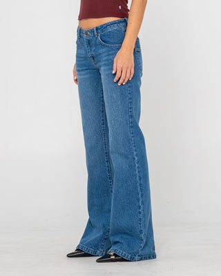 Woman wearing Freida Flare Low Rise Jeans in Blasted Middy Blue