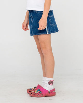 Girl wearing Flip Girl Mini Denim Skirt in Deep Sea Blue