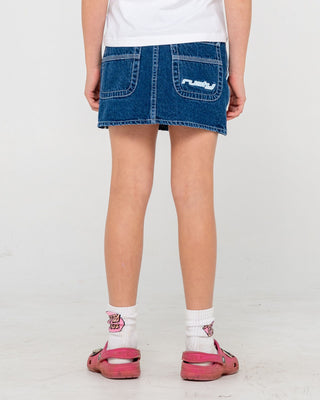 Girl wearing Flip Girl Mini Denim Skirt in Deep Sea Blue