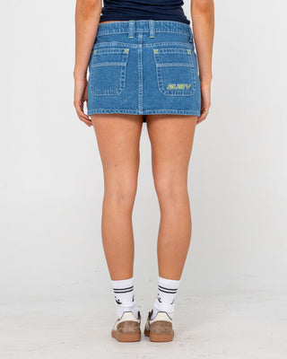 Woman wearing Flip Mommy Low Rise Mini Denim Skirt in Middy Blue / Lime