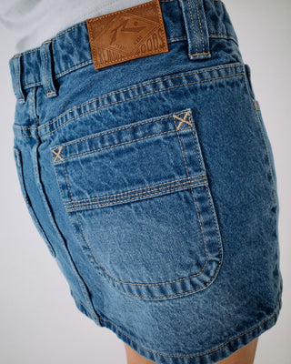Woman wearing Mavericks Low Rise Denim Mini Skirt in Blasted Middy Blue
