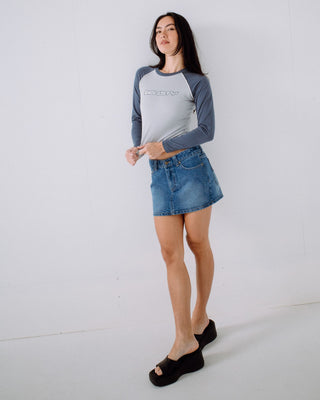 Woman wearing Mavericks Low Rise Denim Mini Skirt in Blasted Middy Blue