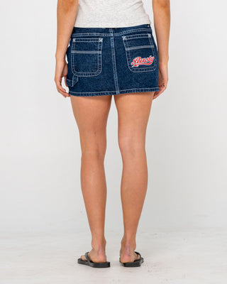 Woman wearing Billie Low Rise Denim Mini Skirt in Indigo