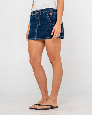 Woman wearing Billie Low Rise Denim Mini Skirt in Indigo