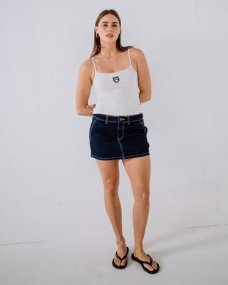 Woman wearing Billie Low Rise Denim Mini Skirt in Indigo