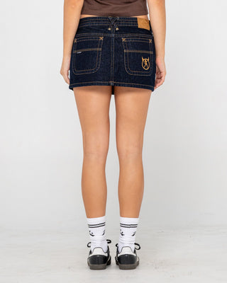 Woman wearing Tripper Raw Low Rise Denim Micro Skirt in Raw Dawg Blue