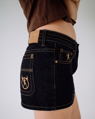 Woman wearing Tripper Raw Low Rise Denim Micro Skirt in Raw Dawg Blue