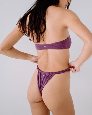 Woman wearing Shimmy String Bikini Bottom in Grape