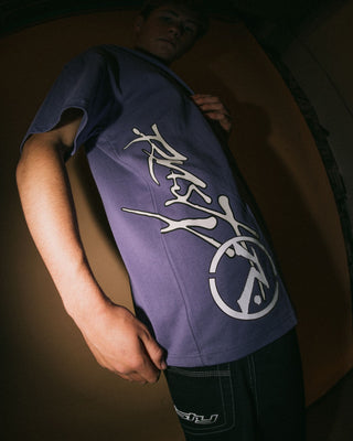 Man wearing Spraya Short Sleeve Tee in Purple Ash