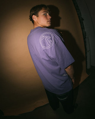 Man wearing Spraya Short Sleeve Tee in Purple Ash