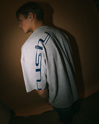 Man wearing Glaze-r Short Sleeve Tee in Grey Marle