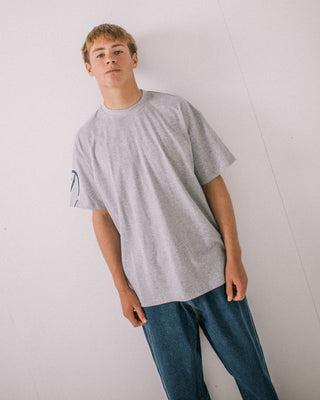 Man wearing Glaze-r Short Sleeve Tee in Grey Marle