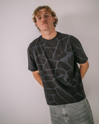 Man wearing Taipan Short Sleeve Tee in Black