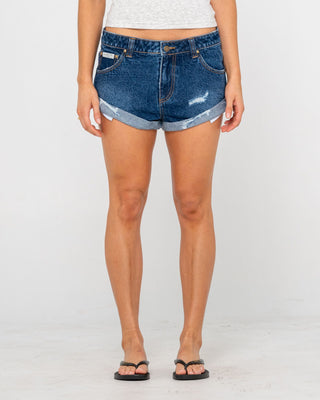 Woman wearing Pheonix Low Rise Denim Mini Short in Blasted Deep Sea Blue
