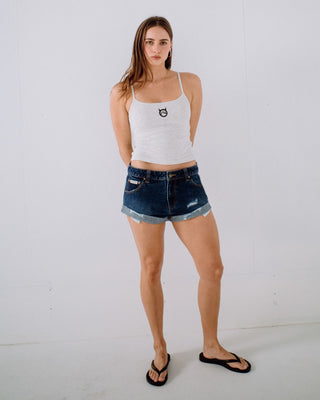 Woman wearing Pheonix Low Rise Denim Mini Short in Blasted Deep Sea Blue