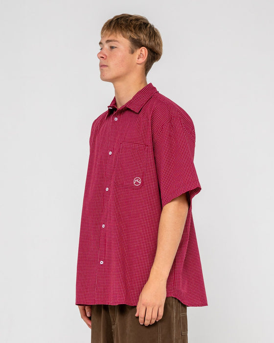 man-wearing-ransom-check-short-sleeve-shirt-in-burgundy