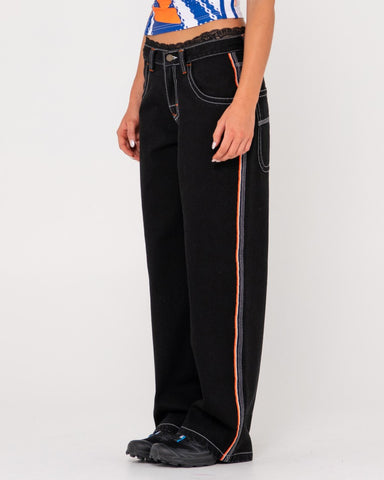 Woman wearing Flip Mommy Low Rise Wide Leg Denim Pant in Black Out / Orange