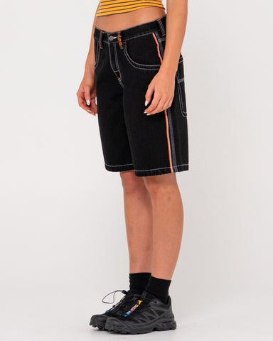 Woman wearing Flip Mommy Low Rise Wide Leg Denim Short in Black Out / Orange