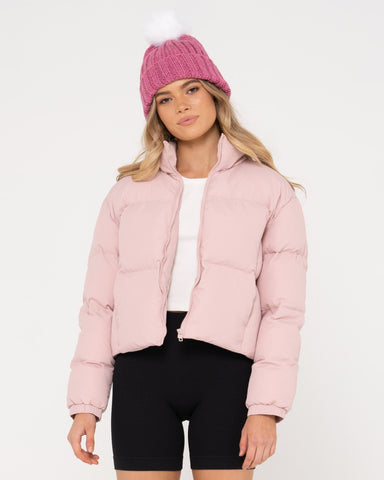 Woman wearing Floreat Puffer Jacket in Pink Clay