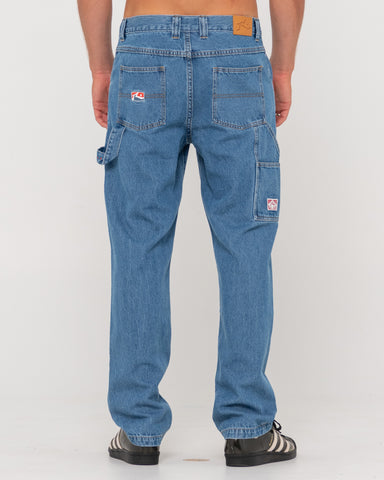Man wearing Dungaree Denim 5 Pkt Pant-middy Blue in Middy Blue