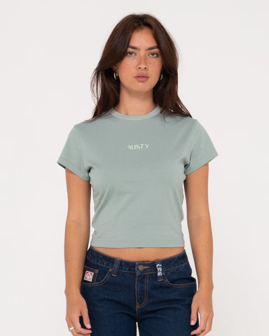 Woman wearing Rusty Signature Skimmer Baby Tee in Faded Pistachio