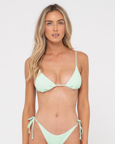 Woman wearing Sandalwood Slick Triangle Bikini Top in Fresh Mint