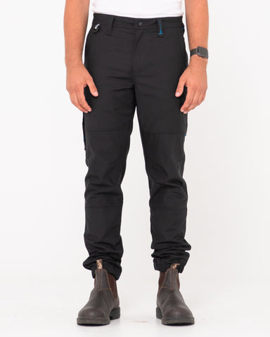 Man wearing Tr246 9 Pocket Stretch Work Pant Cuffed in Black