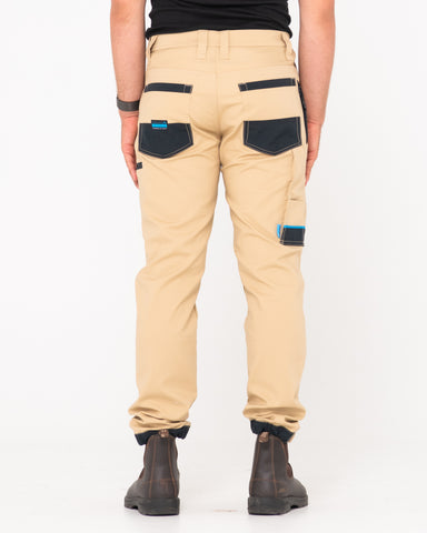 Man wearing Tr246 9 Pocket Stretch Work Pant Cuffed in Trade Khaki