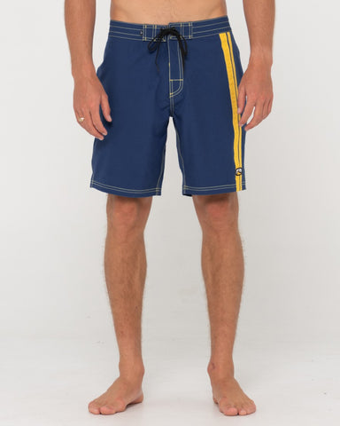 Man wearing Burnt Rubber Fitted Boardshort in Navy / Gold
